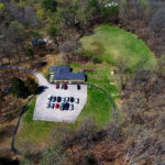 Drone view of property including driveway