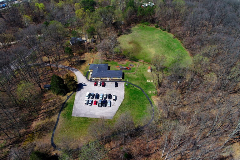 Drone view of property including driveway