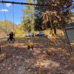 older kids playground swing set with kids swinging