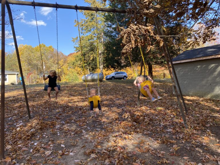 older kids playground swing set with kids swinging